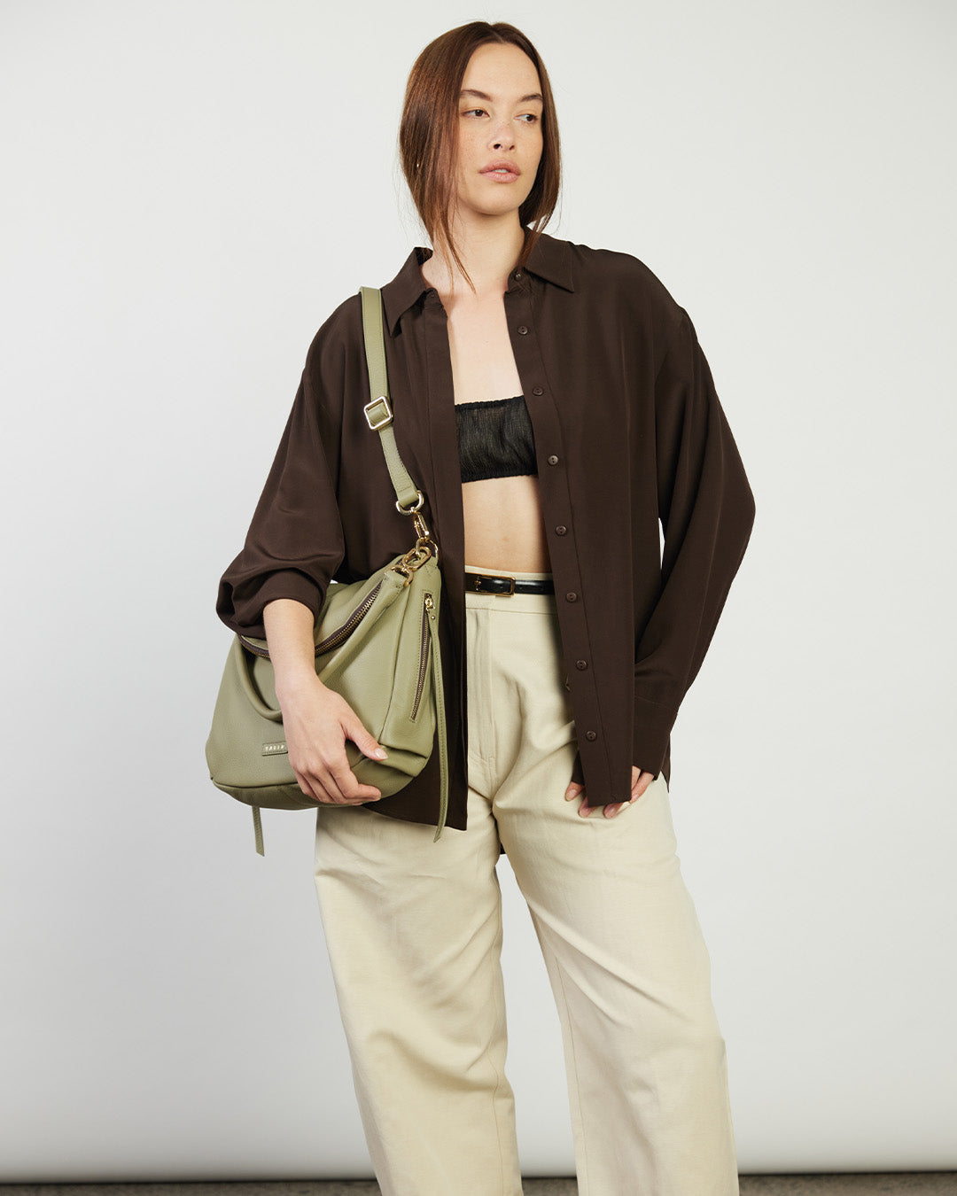 Green handbag with a visible brand logo on a white background